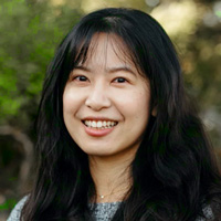 Christina Chang smiling at camera with trees in the background